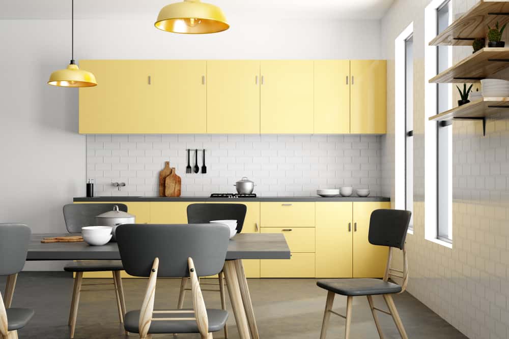 yellow kitchen with white tiles backsplash