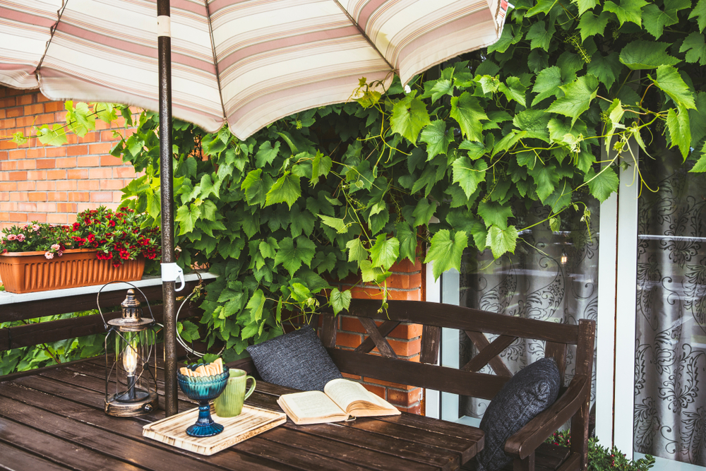 open balcony with a café style table with an umbrella