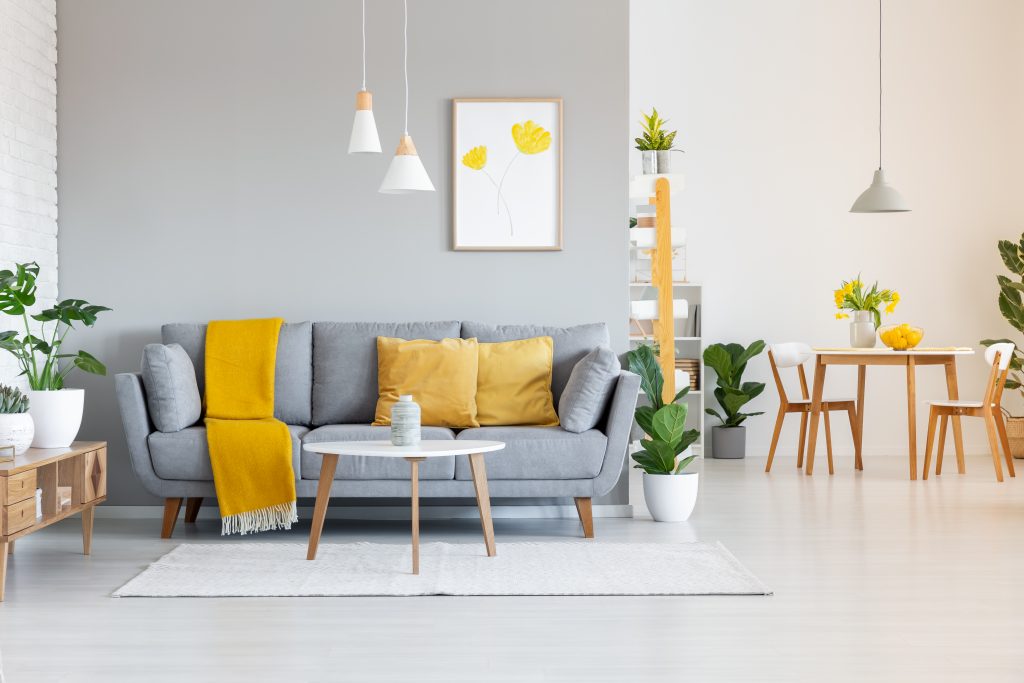 mustard yellow cushions and grey sofa