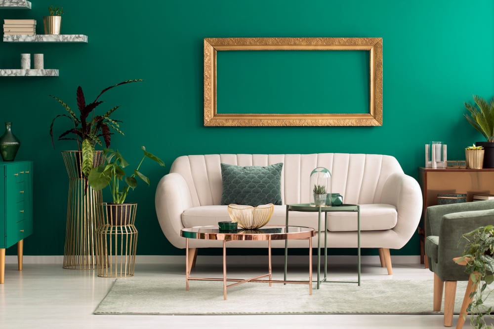 green colour wall with cream sofa