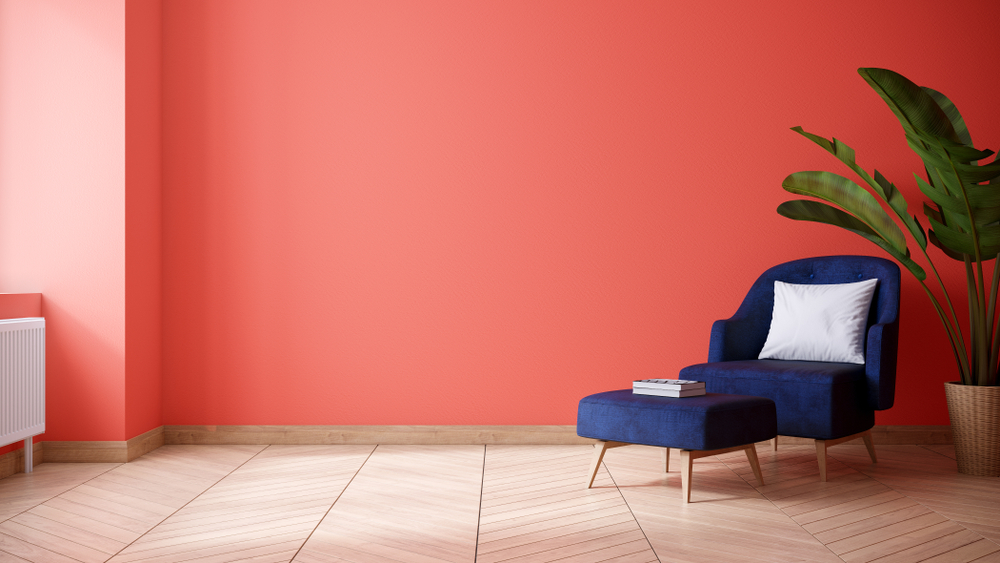 coral walls with Navy blue sofa