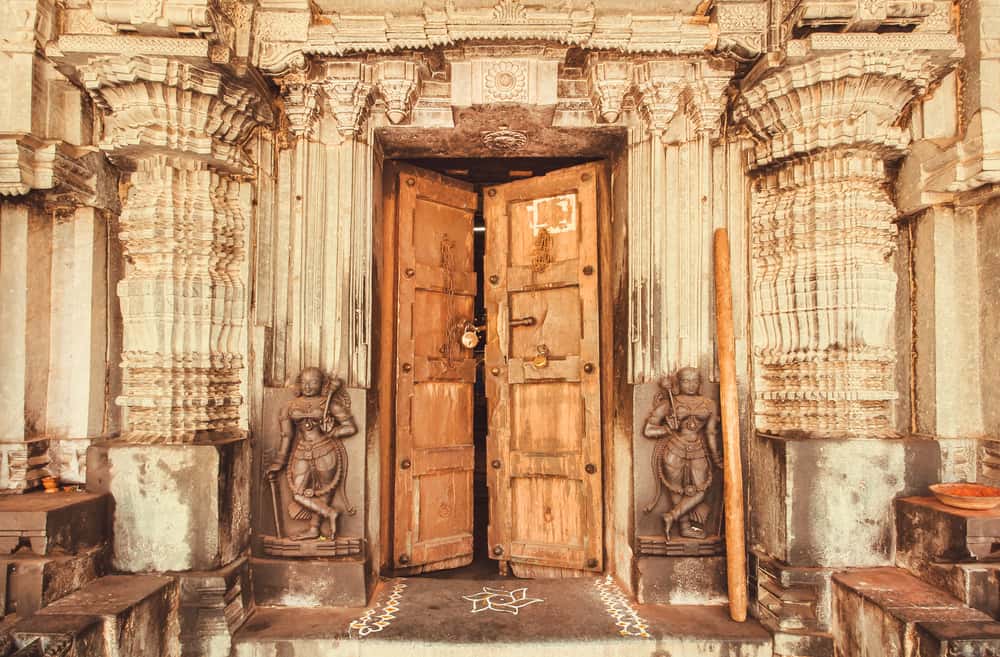 pooja room with pillars and wooden doors