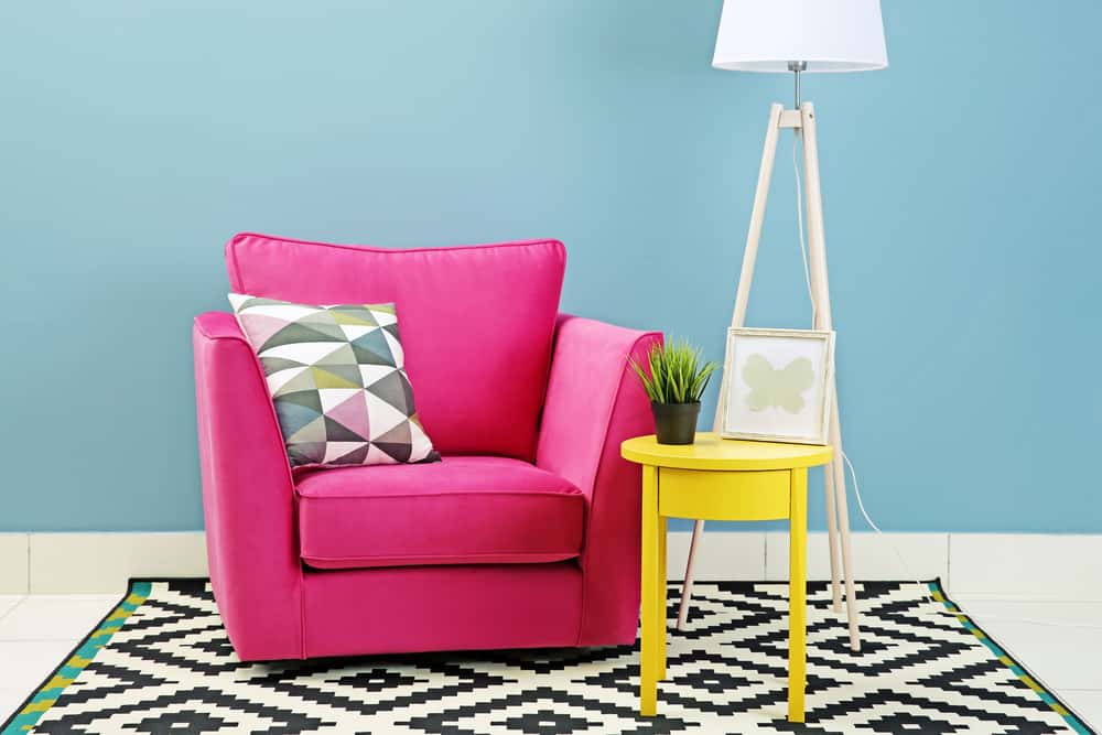 colourful pink sofa and yellow side table