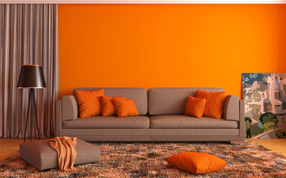 zesty orange living room with brown furnishing