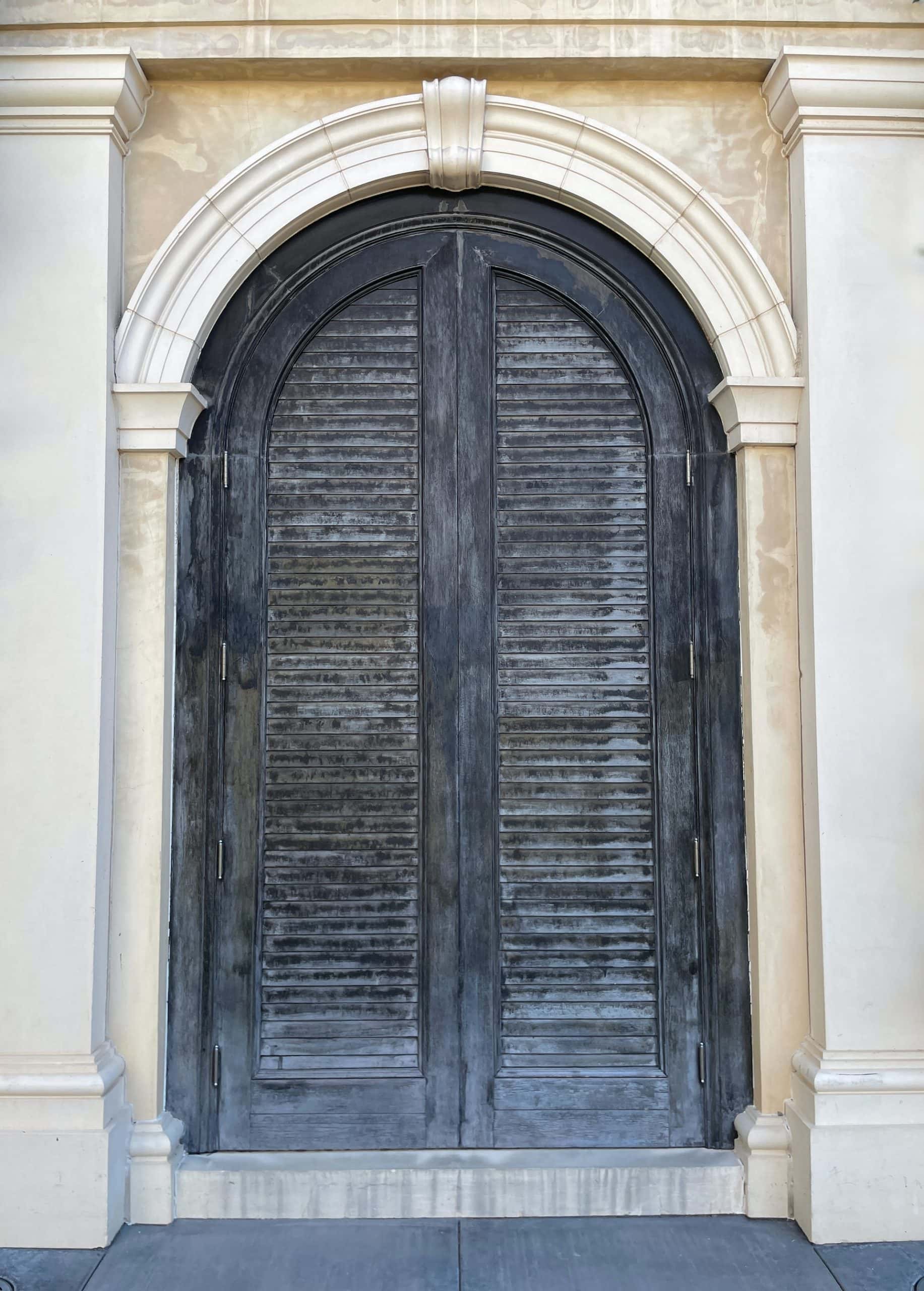 arched double doors with wooden grooves
