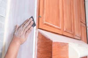 Handyman Using Piece Sandpaper Smoothen Out