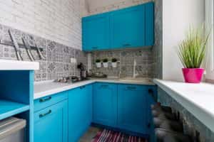 very small kitchen blue cabinets window